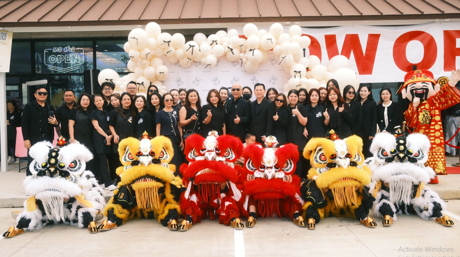 Nails of America Fulshear team and guests with lion dance performers at the grand opening ceremony