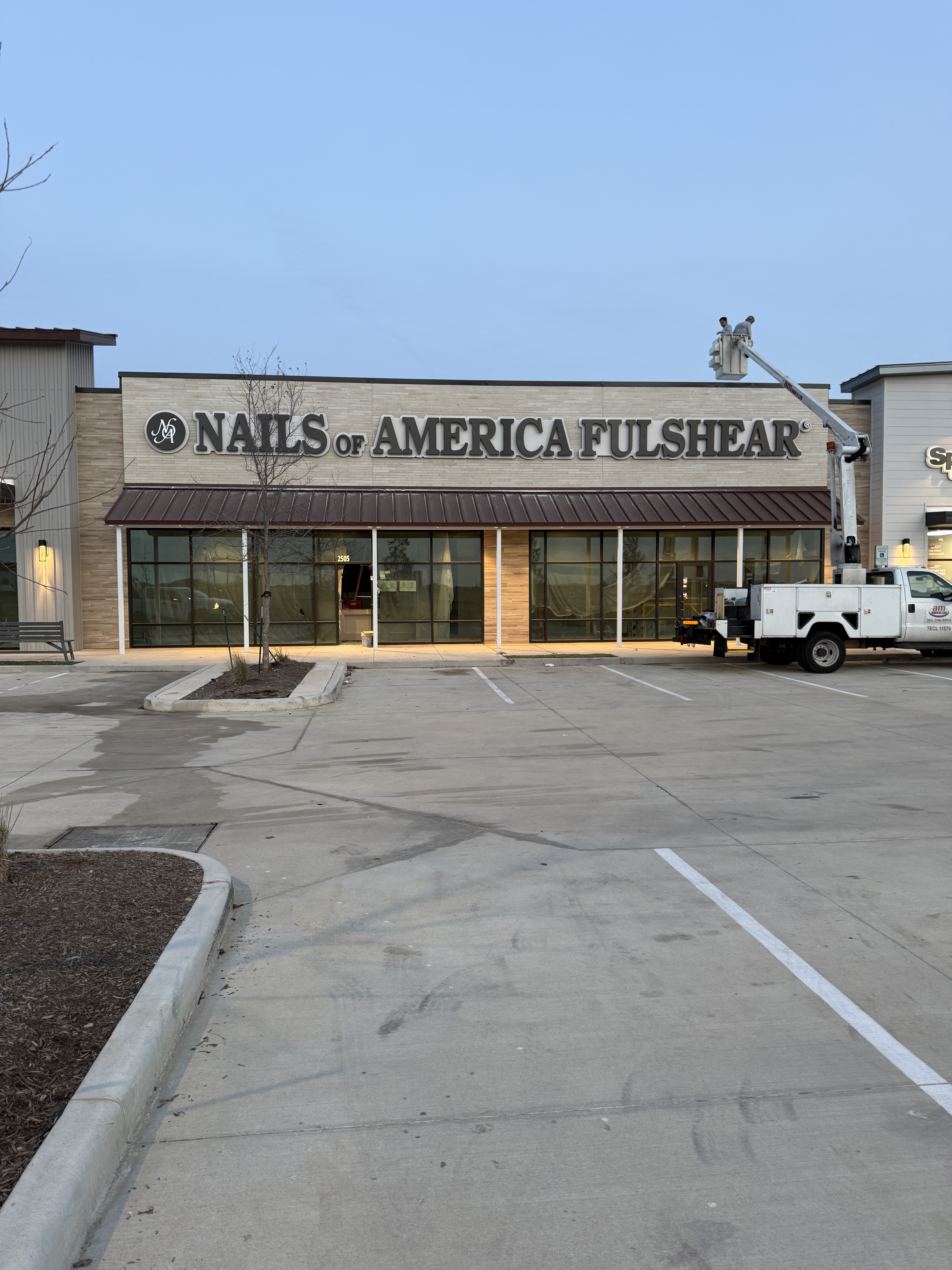 Exterior view of Nails of America Fulshear salon storefront