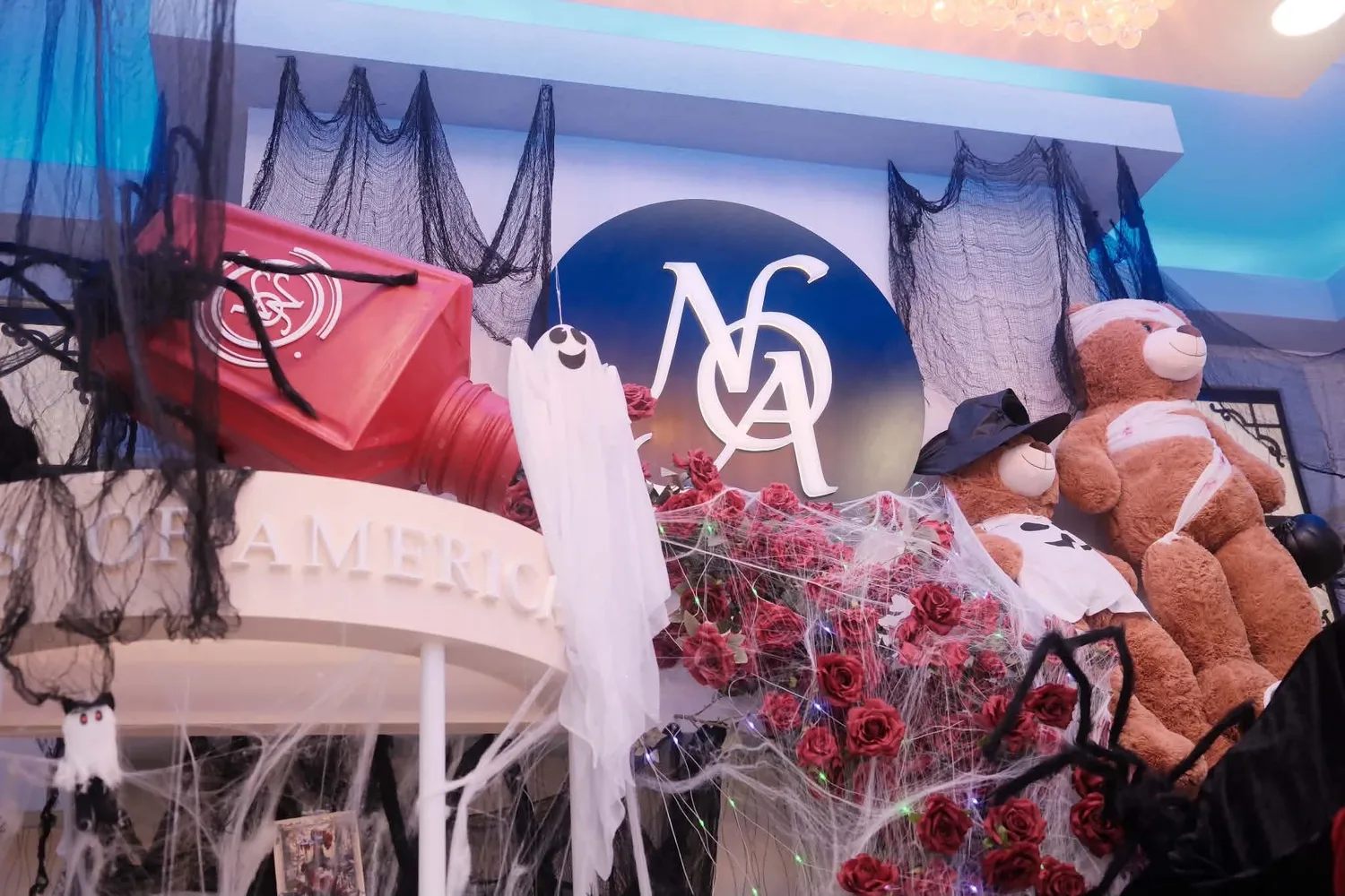 Halloween decorations around the Nails of America logo