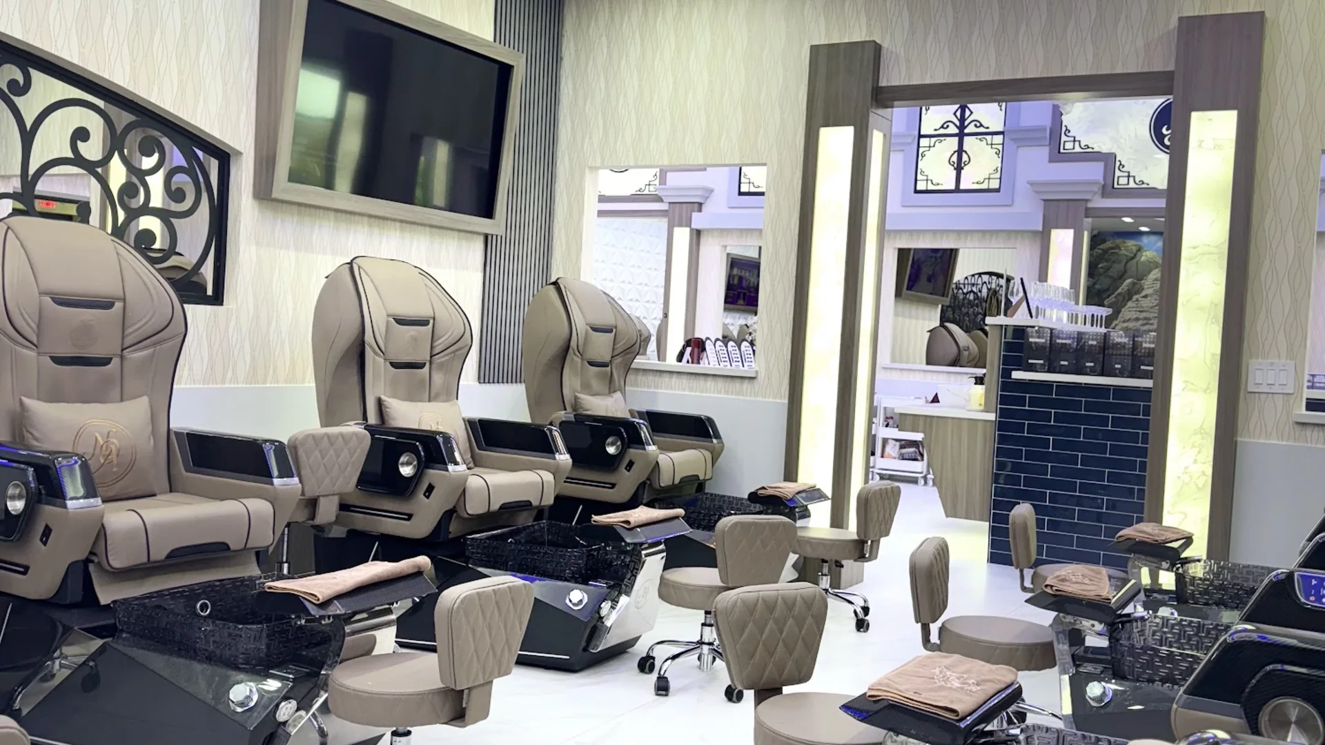 Rows of luxury massage pedicure chairs inside Nails of America Fulshear