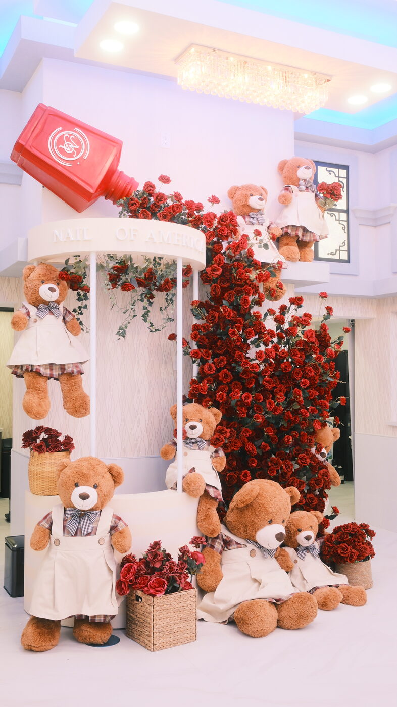 Signature floral and teddy bear display inside Nails of America Fulshear