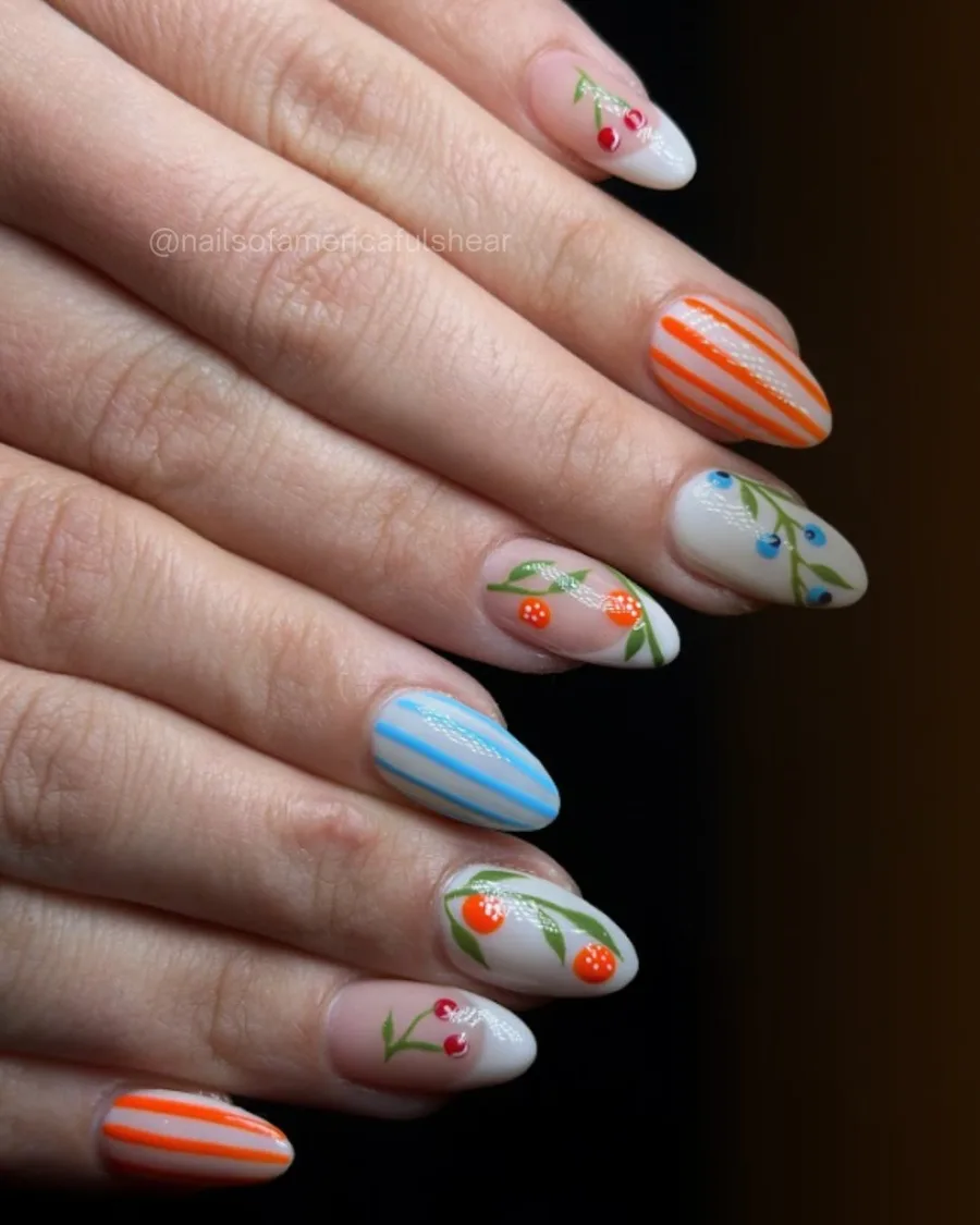 Pastel nails with cherry accents and fine stripes